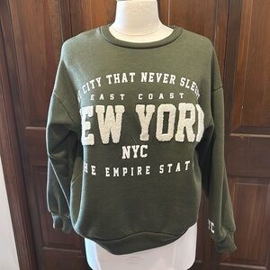 Green NYC woman’s sweatshirt